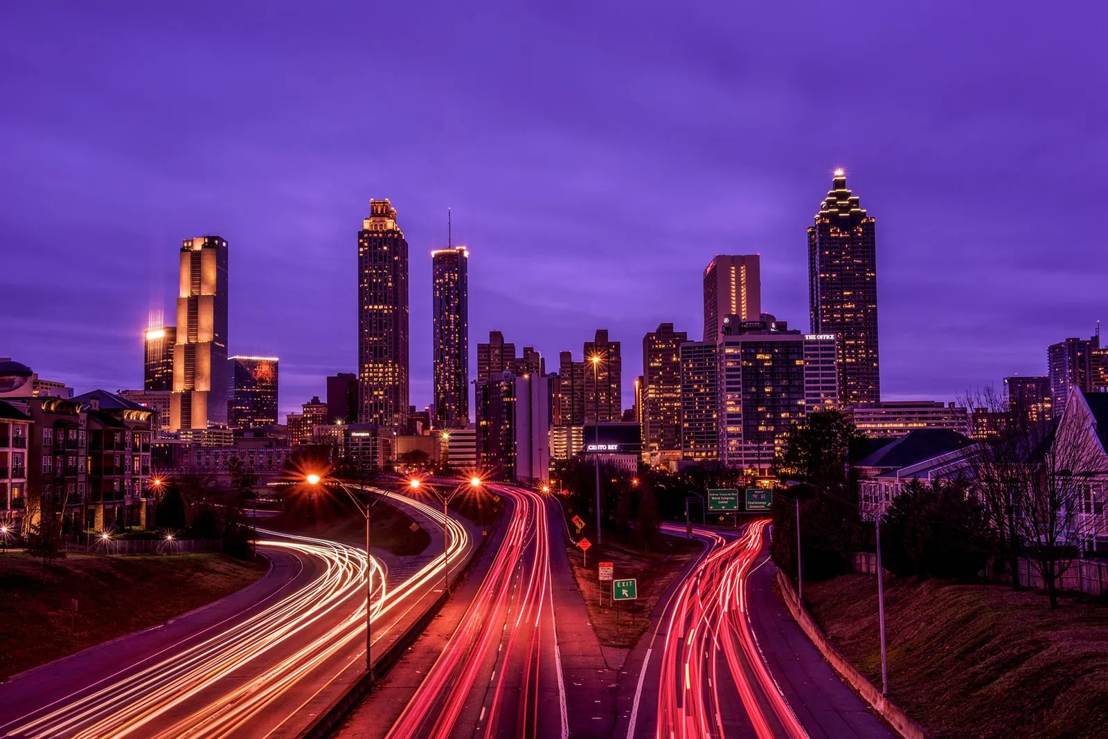 The Atlanta skyline at dusk with highway light trails below